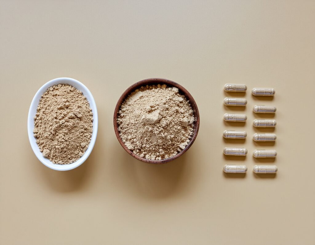 Maca powder in bowls and capsules