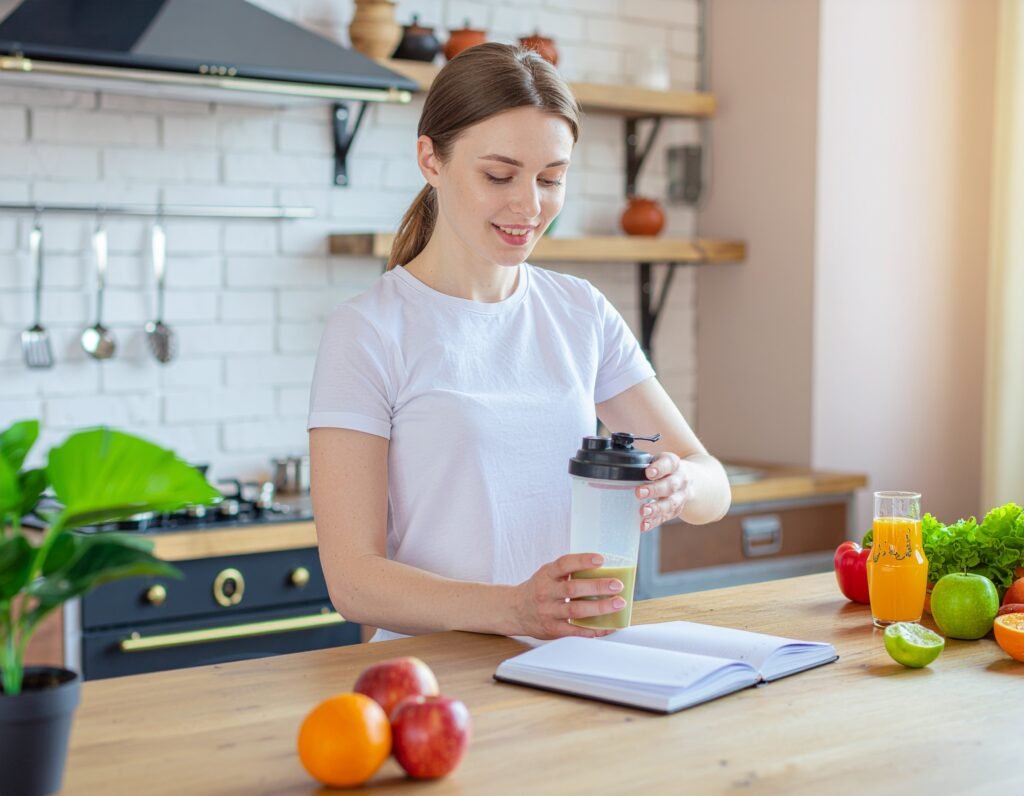 Focused person enjoying a shaker of BioVanish at a bright desk