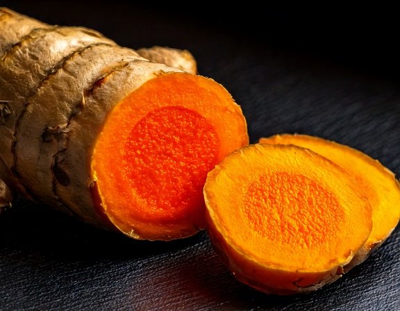 Bright orange turmeric rhizome sliced open