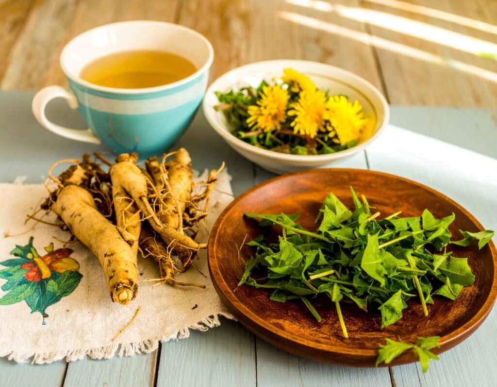 Fresh dandelion roots and leaves on a kitchen table, mug of roasted tea