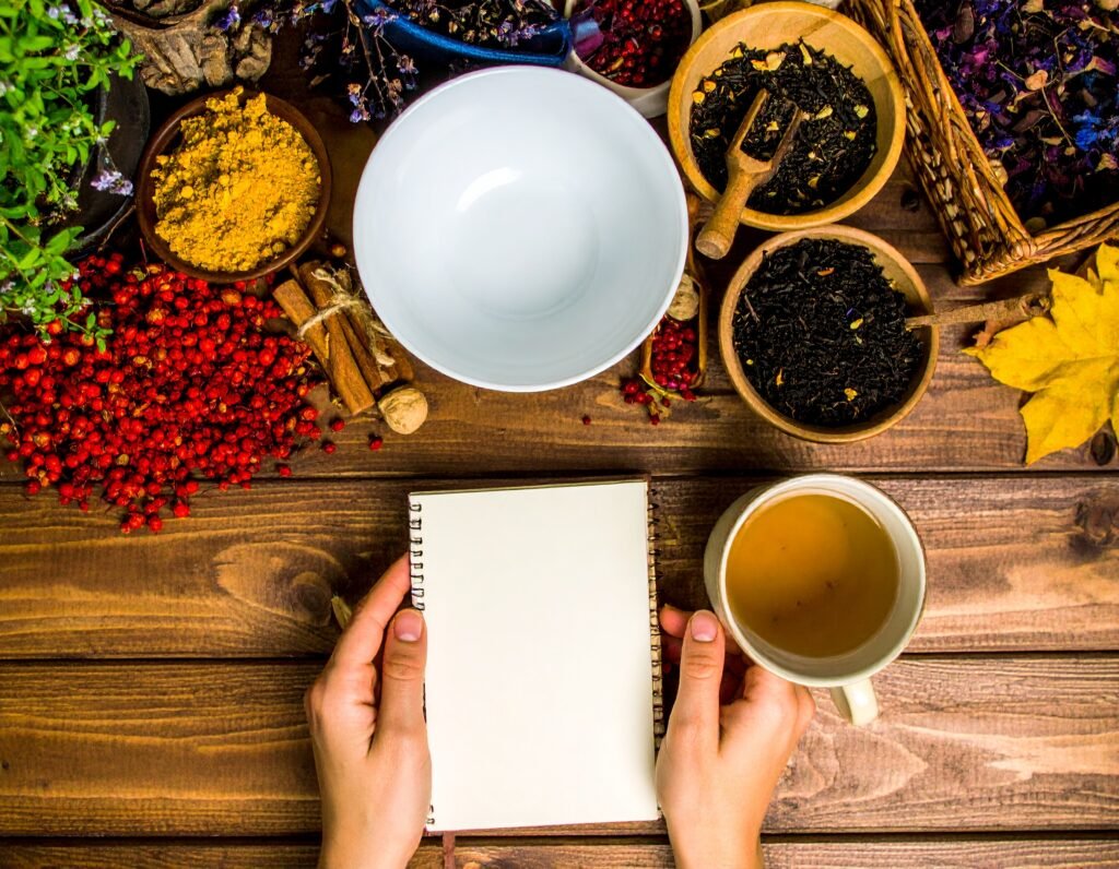 Happy gardener journaling with mug of herbal tea and fall herbs
