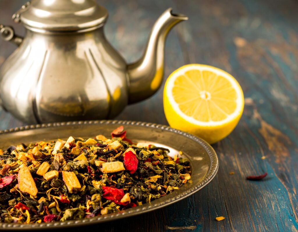 Roasted dandelion roots on a baking tray, sliced and ready to brew