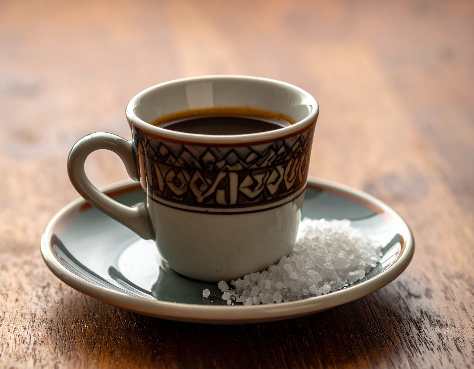 Ethiopian coffee cup with sea salt on saucer